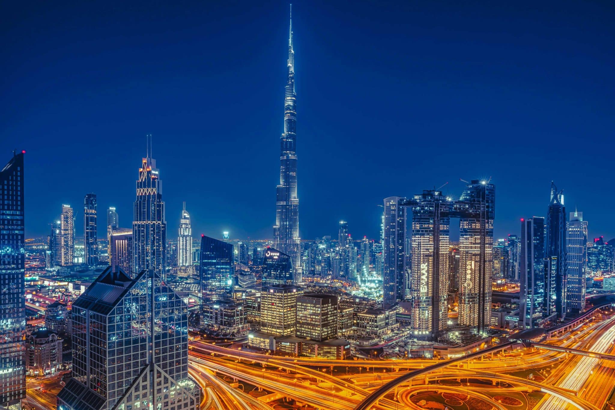 Night view of Dubai skyline with the Burj Khalifa and brightly lit roads